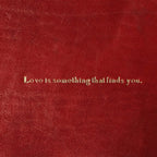 Piccolo vassoio in pelle rossa con frase “Love is something that finds you.” incisa