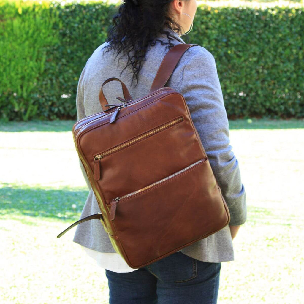 Brown full-grain calfskin backpack, front view with a zip pocket