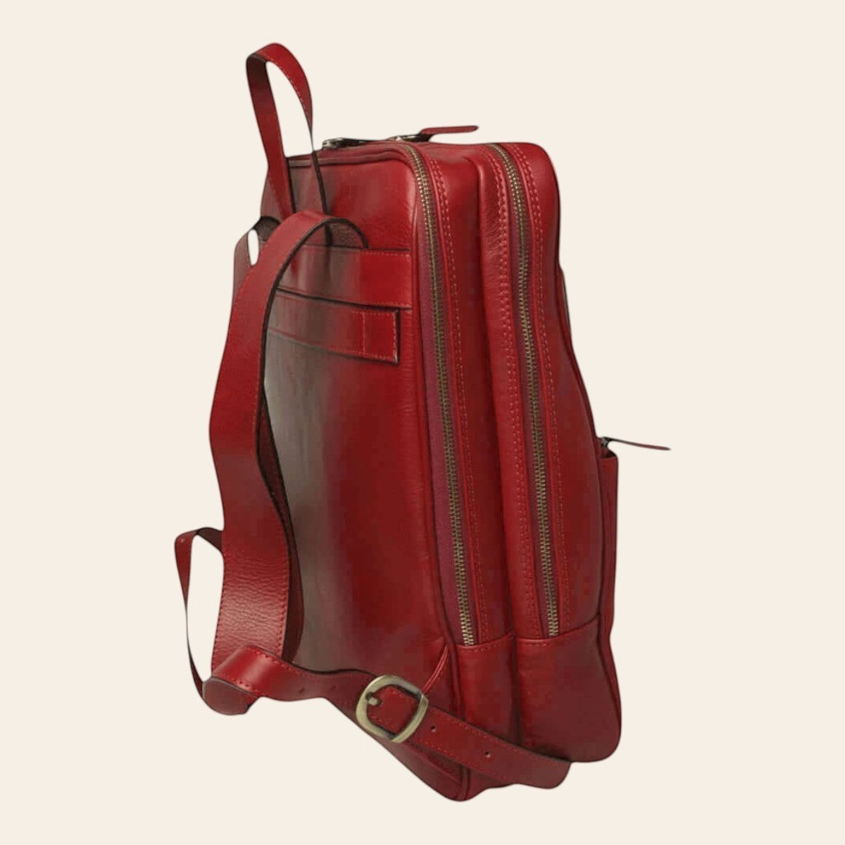 Mochila de piel de becerro en color rojo, vista lateral con dos compartimentos con cremallera y tirantes