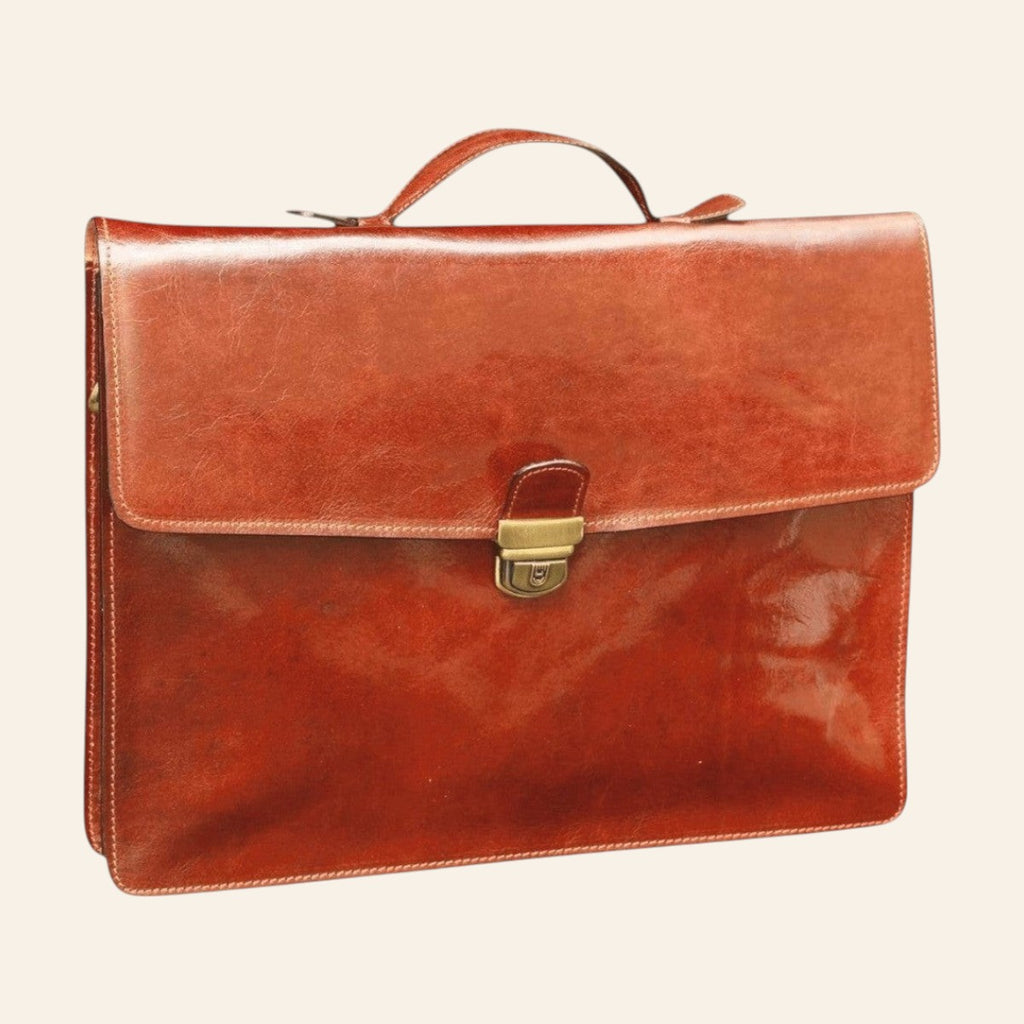 Brown full-grain calfskin briefcase front view with top handle and front closure