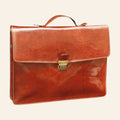 Brown full-grain calfskin briefcase front view with top handle and front closure