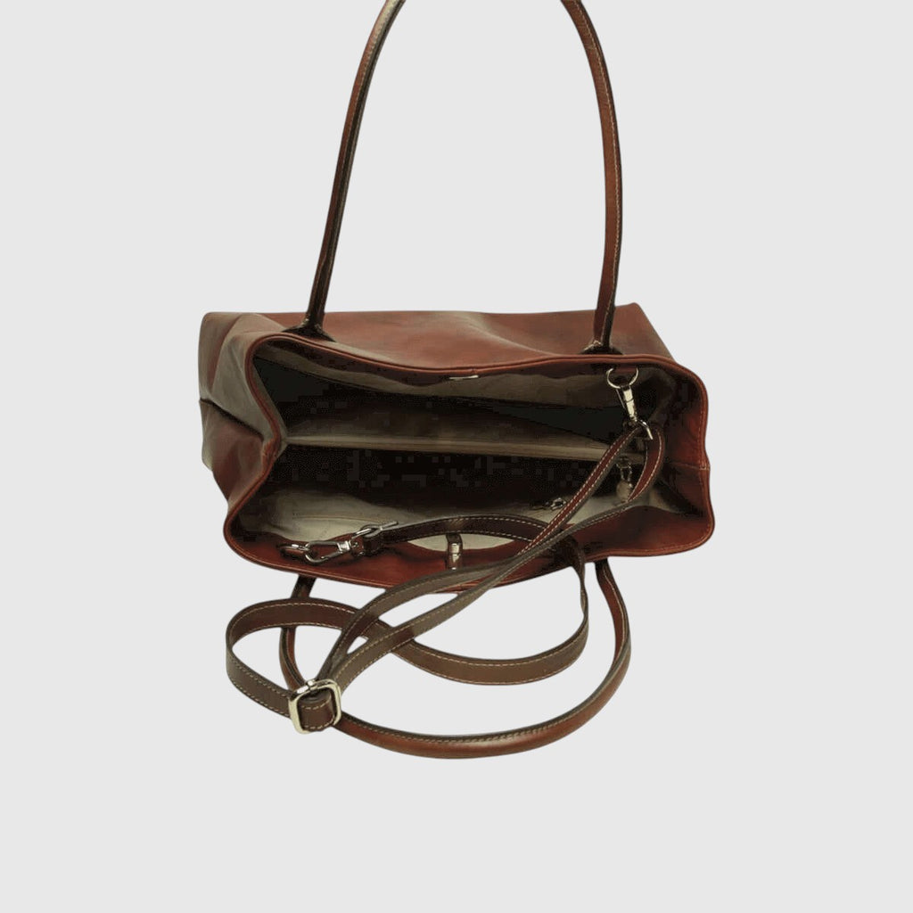 Borsa in pelle mogano aperta con interno scuro e tracolla regolabile