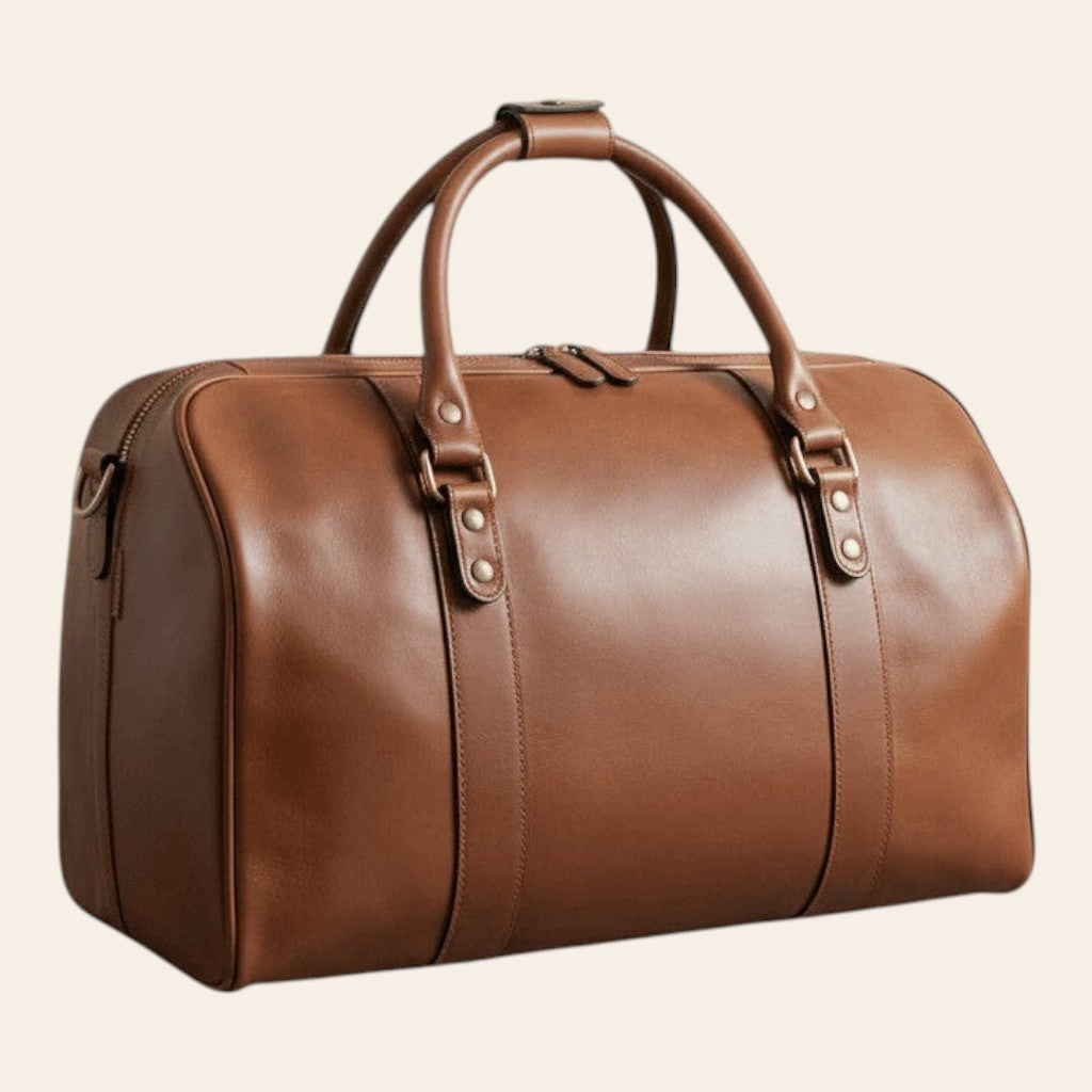 Borsa da viaggio in pelle di vitello color castagna, vista di tre quarti con doppi manici e chiusura superiore con zip