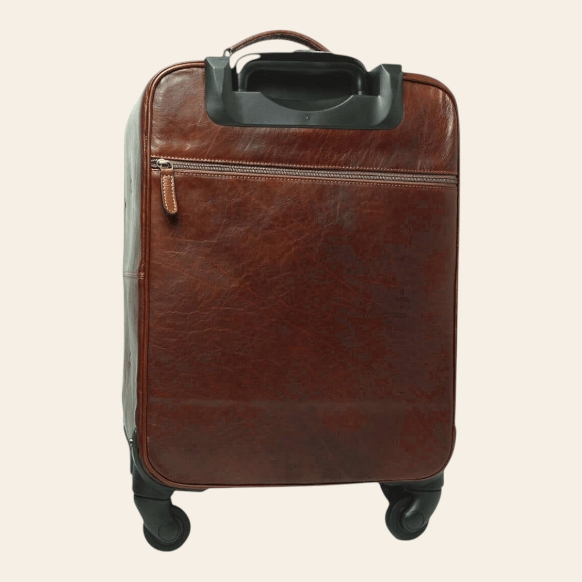 Trolley in pelle marrone con profilo arrotondato e maniglia estraibile; ruote.