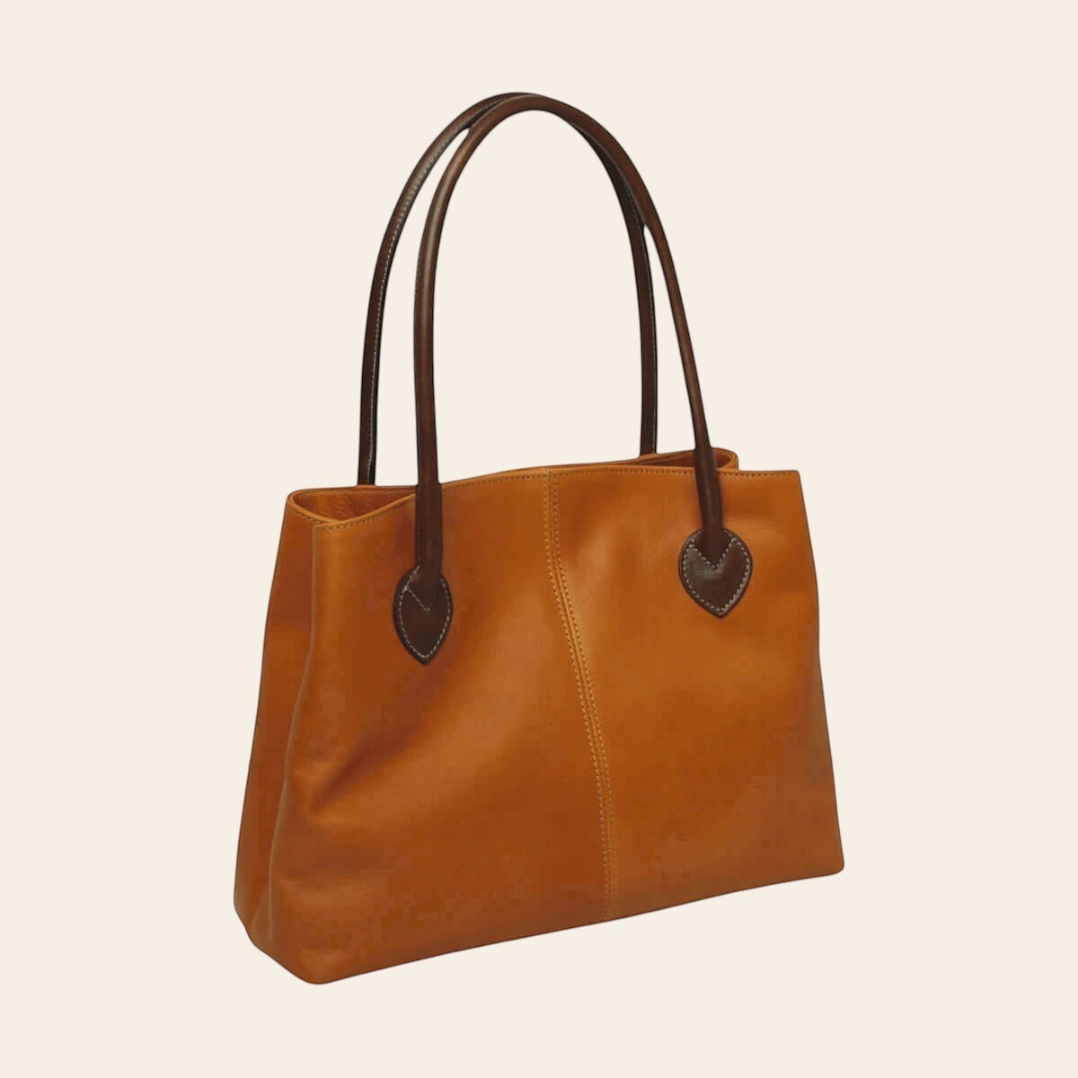 Borsa in pelle bicolore giallo ocra con due manici marrone scuro e dettagli in rilievo.