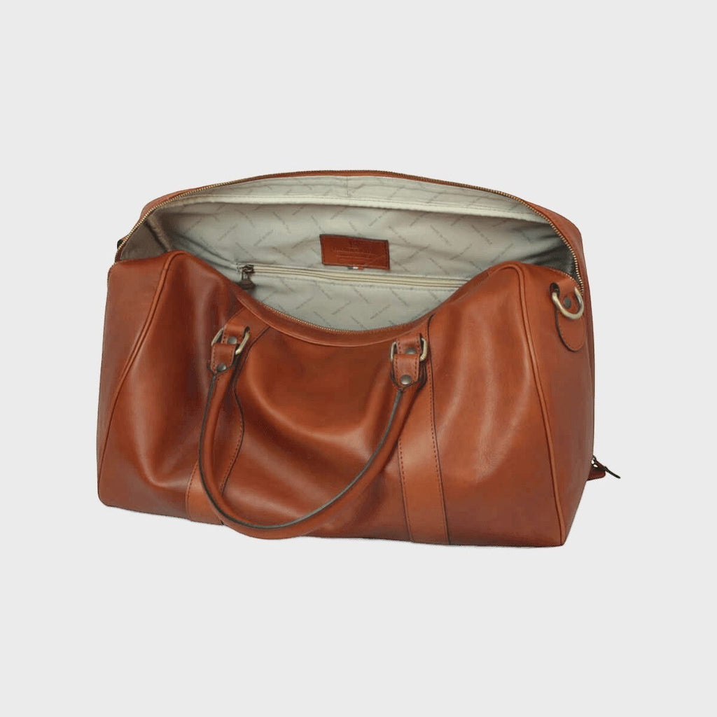 Borsa da viaggio in pelle pieno fiore cuoio, vista interna con fodera chiara e tasca.