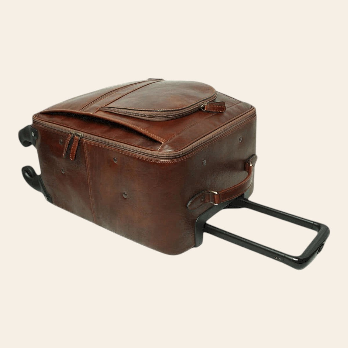 Trolley in pelle marrone con maniglia estesa e tracolla laterale; ruote.