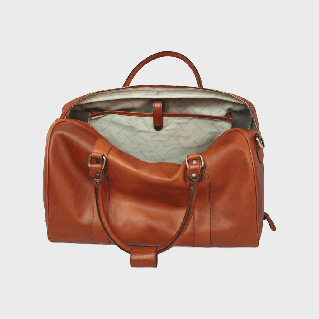 Borsa da viaggio in pelle pieno fiore cuoio, vista interna con fodera chiara e tasche.