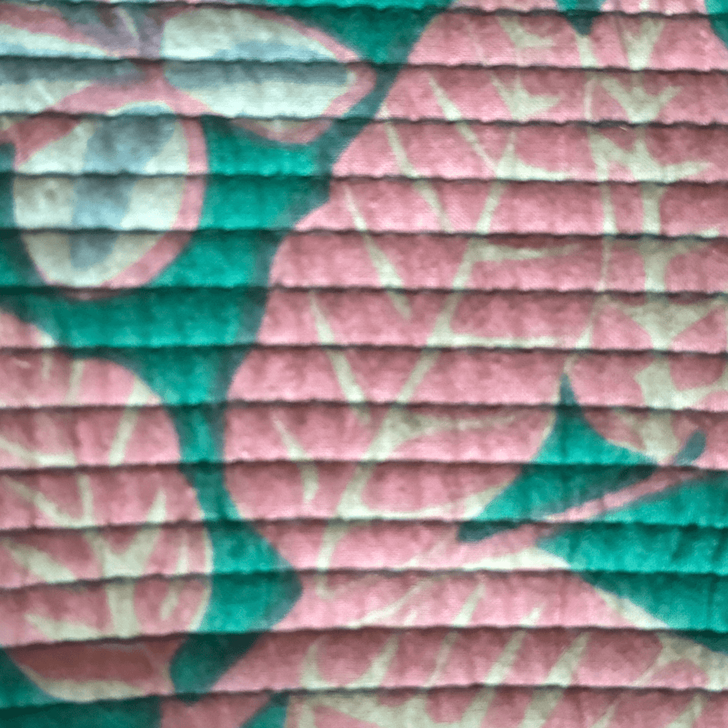 Roary Pouches 🐾 Maldives in vibrant floral patterns, displayed on a wooden surface with tropical greenery.