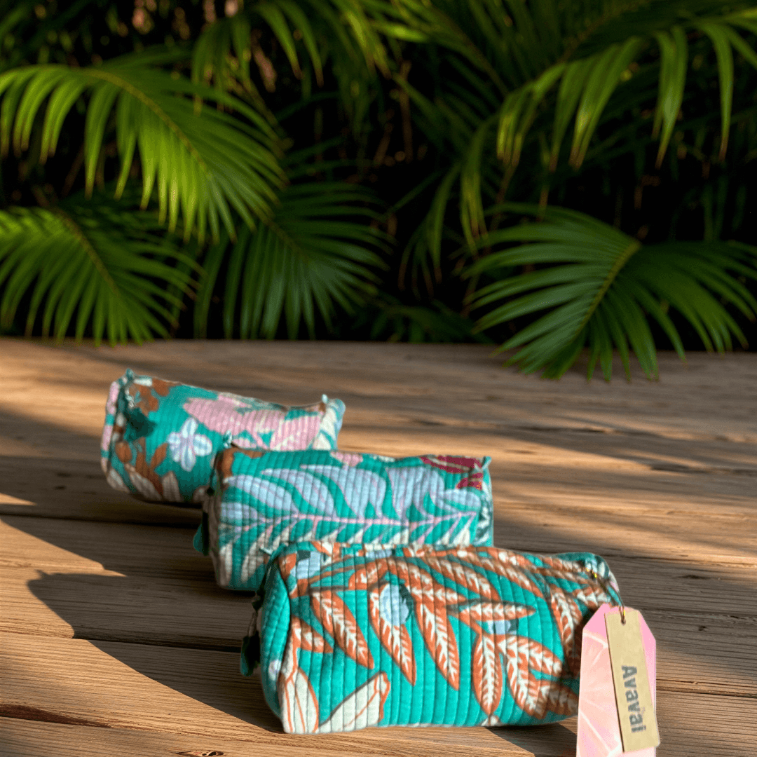 Roary Pouches 🐾 Maldives in vibrant floral patterns, displayed on a wooden surface with tropical greenery.