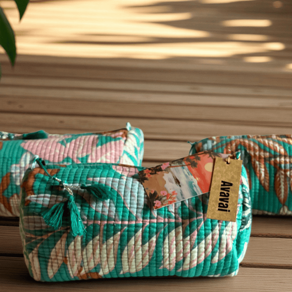 Roary Pouches 🐾 Maldives in vibrant floral patterns, displayed on a wooden surface with tropical greenery.