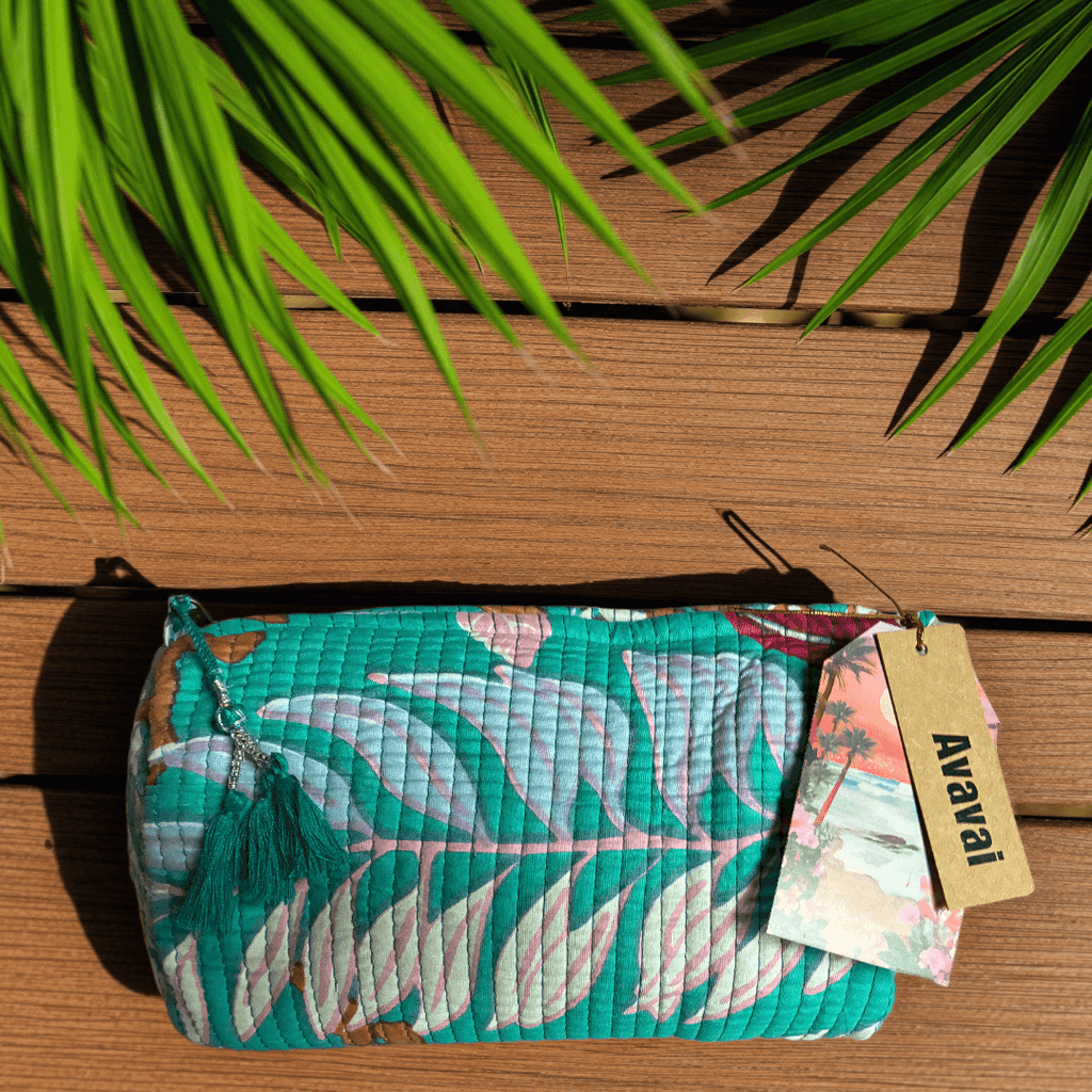 Roary Pouches 🐾 Maldives in vibrant floral patterns, displayed on a wooden surface with tropical greenery.
