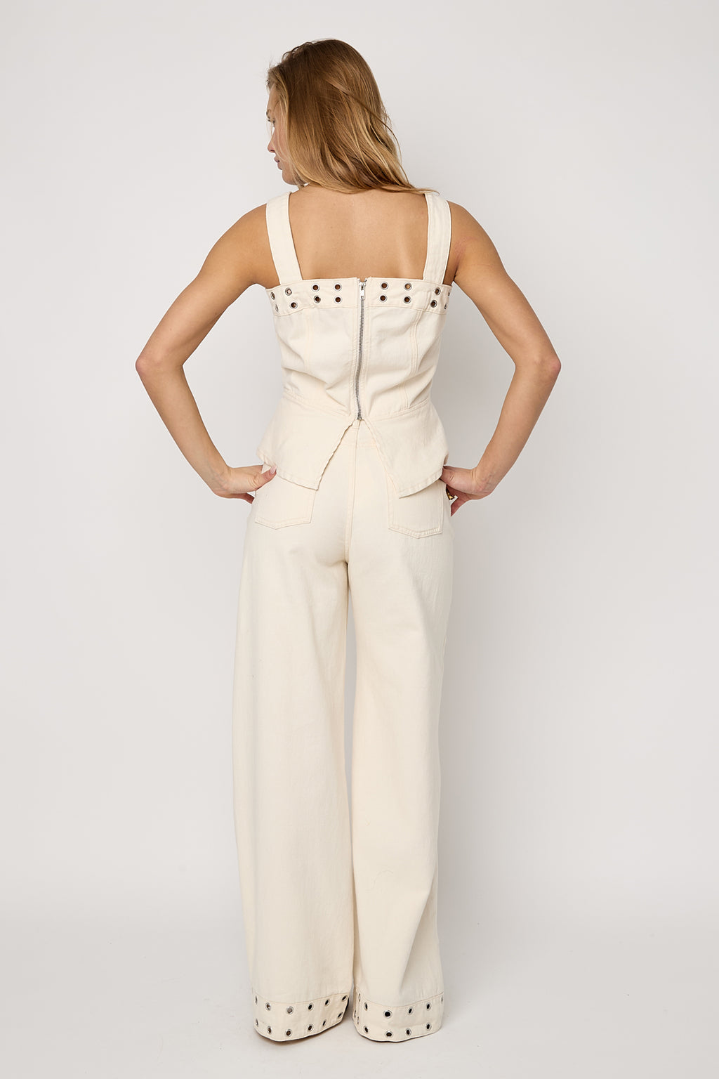 Top in denim con occhielli